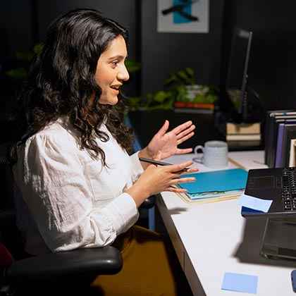woman in home office video conferencing on laptop. 
