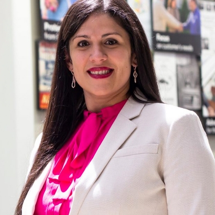 female call center employee smiling with headset on. 