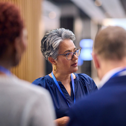 Woman sitting sitting at a conference table during a meeting. 