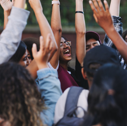 Group cheering with hands up in the air. 