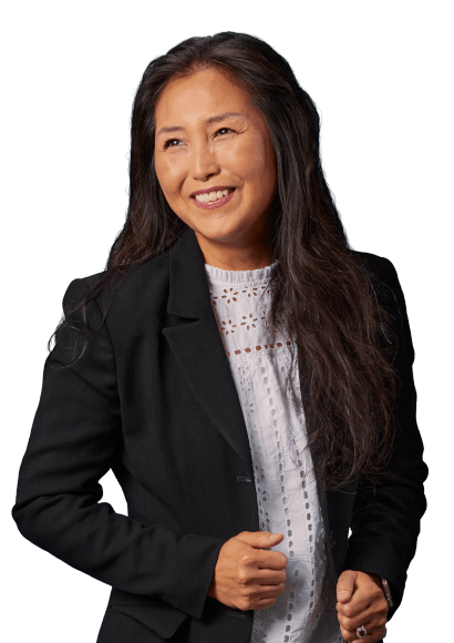 Woman wearing black blazer smiling looking off to the side. 