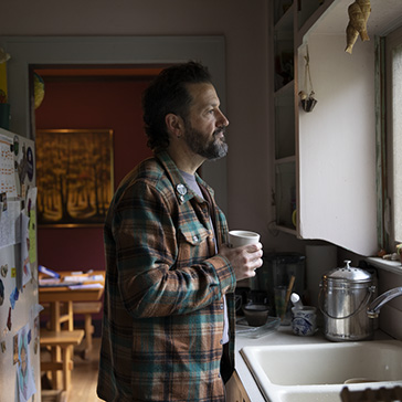Man in kitchen.