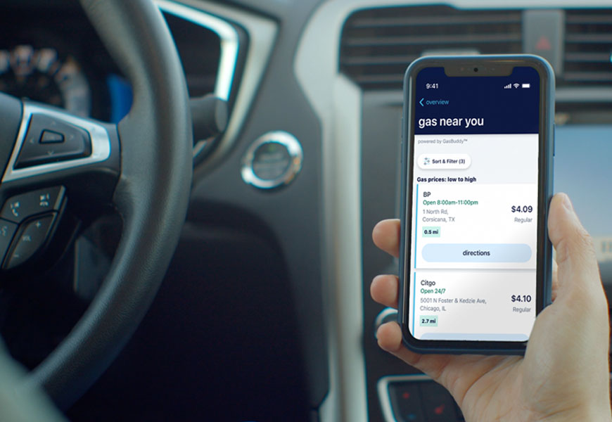 A hand holds a mobile phone with the Allstate® app's new feature, GasBuddy®, on the screen. 