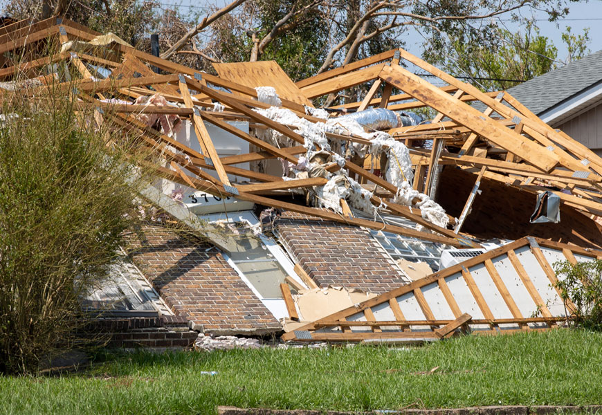 Close up of a collapsed brick house after a hurricane.